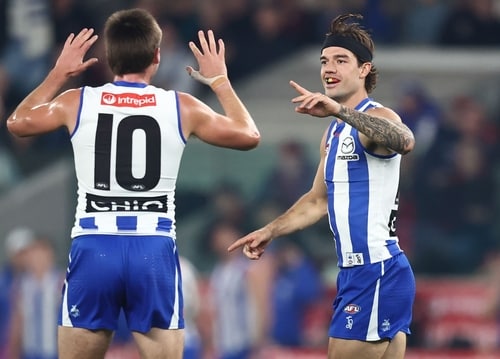 North Melbourne players in action against Essendon at Marvel Stadium